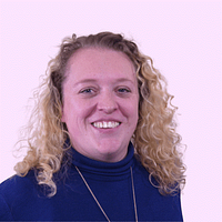 A head and shoulders photo of a smiling woman