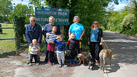 A group of young people, adults and dogs smiling