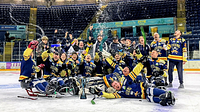 A group of Sheffield Steelkings Para Ice Hockey Club players cheer and celebrate on the ice rink.