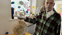 A man showing off a carved wood shell