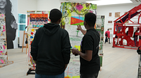 Two young men looking at a poster