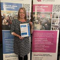 A lady holding a certificate