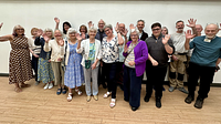 A group of adults stood together cheering