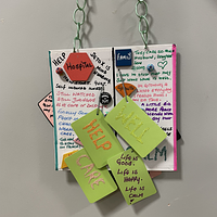 A hanging sign with thoughts and motivational words