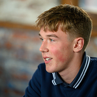 close up image of a young man smiling